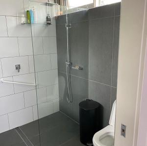 a bathroom with a shower and a toilet at L'École Private Studio-Apartment by My Lodgingfy in Moorabbin