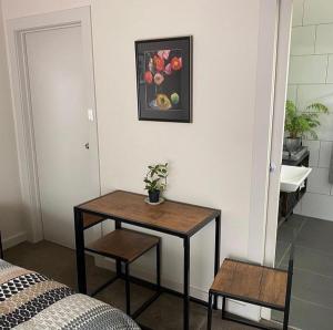 a table and two chairs in a room at L'École Private Studio-Apartment by My Lodgingfy in Moorabbin