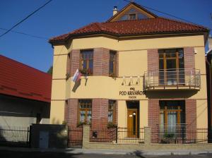 a building with a sign on the front of it at Penzion pod Krivanom in Liptovský Hrádok