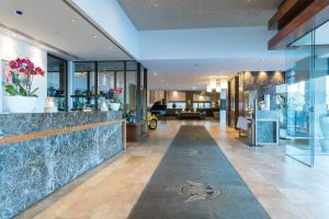 a lobby of a building with glass walls and a lobby at RACV Healesville Country Club & Resort in Healesville