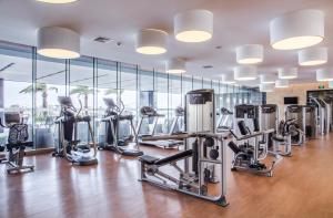 a gym with several treadmills and elliptical machines at Holiday Inn Putian Xiuyu, an IHG Hotel in Putian