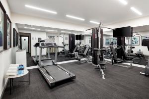 a gym with treadmills and machines in a room at Quest St Kilda Road in Melbourne