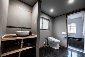 a bathroom with a sink and a toilet at シャローム伊豆高原 in Futo