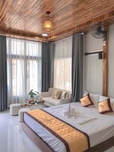 a bedroom with a large bed and a living room at Trang An Memory Homestay in Ninh Binh
