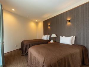 Postel nebo postele na pokoji v ubytování Condominium T-Room