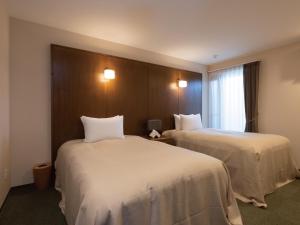 Postel nebo postele na pokoji v ubytování Condominium T-Room