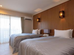 Postel nebo postele na pokoji v ubytování Condominium T-Room