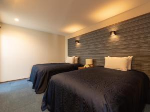 Postel nebo postele na pokoji v ubytování Condominium T-Room