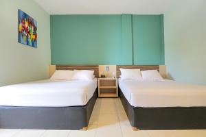 מיטה או מיטות בחדר ב-Sun In Pangandaran Hotel