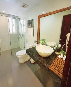 a bathroom with a sink and a shower and a toilet at Hanoi Amorita Boutique Hotel & Travel in Hanoi