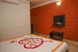 a cake with a flower on top of it at Hotel On The Rocks to Hotel On The Rocks With Swimming in Mahabaleshwar