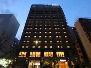 
a tall building with a large window at Dormy Inn Ikebukuro in Tokyo
