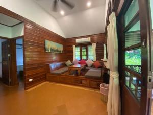 a living room with a couch and a table at Smile House - Fisherman Village in Bophut
