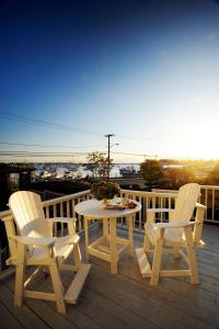 a patio area with chairs, tables and umbrellas at The Inn at Scituate Harbor in Scituate