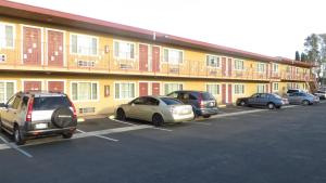 a group of cars parked in a parking lot in front of a building at Cloud 9 in Cypress