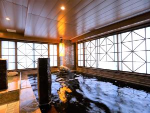 东京Dormy Inn Ikebukuro的带窗户的天花板上设有池塘的房间