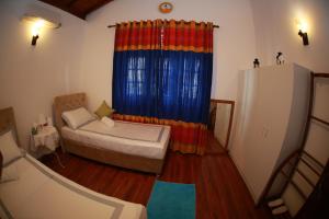 Postel nebo postele na pokoji v ubytování Colombo Orchid Villa
