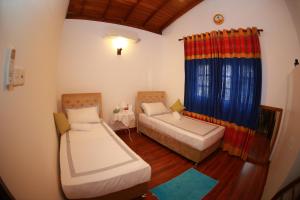 Postel nebo postele na pokoji v ubytování Colombo Orchid Villa