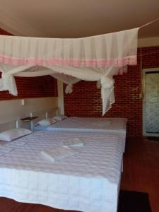 a bedroom with a large bed with a canopy at Rice straw Green lodge- resort in Quan Tom