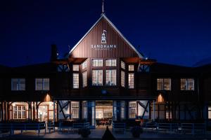 a large building with a sign on it at night at Sandhamn Seglarhotell in Sandhamn