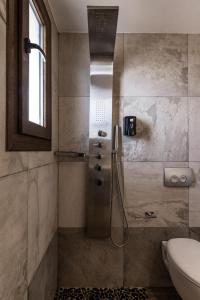 a bathroom with a shower with a toilet and a sink at GARDELLI RESORT in Laganas