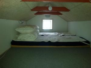 uma cama num pequeno quarto com uma janela em Aarhus Syd Holiday Apartment em Beder