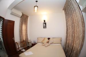 Postel nebo postele na pokoji v ubytování Colombo Orchid Villa