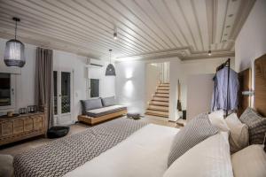 a bedroom with a large bed and a couch at Luxury Apartment in the Heart of Astypalaia in Astypalaia