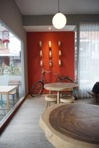 a room with a table and a bike against a wall at Hotel Pantes Semawis Pecinan SMG - Petfriendly Hotel in Semarang