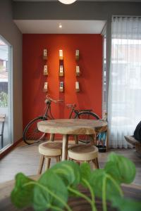 a room with a table and a bike against a wall at Hotel Pantes Semawis Pecinan SMG - Petfriendly Hotel in Semarang +27 photos