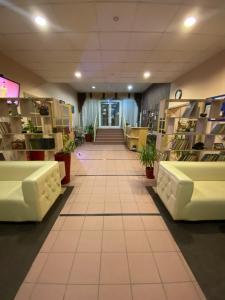 a store aisle with white tables and shelves with plants at Continental Hotel in Rostov on Don