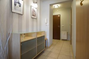 a bathroom with a sink and a hallway with a door at Apartamenty na Równi w Centrum Apartzakop in Zakopane