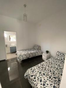 A bed or beds in a room at CASA REFORMADA CON TERRAZA/WIFI/AIRE ACONDICIONADO