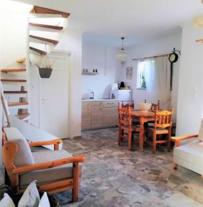 a kitchen and dining room with a table and chairs at Perigiali beach apartment - 2 free bikes in Periyiálion
