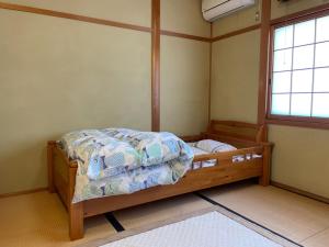 a bedroom with a bed in a room with a window at Houtouji Temple in Yoshino