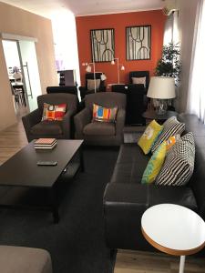 a living room with a couch and a table at Casas de Luanda GH-Miramar in Luanda