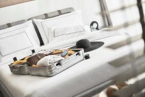 A bed or beds in a room at The G Hotel Seashell