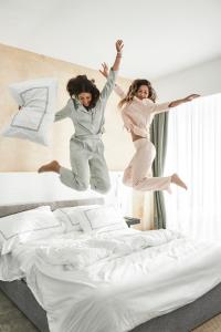 A bed or beds in a room at The G Hotel Seashell