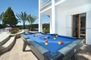 a pool table with balls on it on a patio at Villa Hortet in Cala d´Or