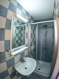 a bathroom with a sink and a shower at Crystallo Apartments in Paphos