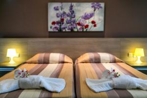 two beds with towels and stuffed animals on them at Crystallo Apartments in Paphos