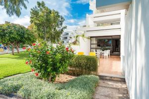 a white house with a garden and a patio at Oiza Garden at Alcudia beach with WIFI and AACC, BahiaBlanca in Alcudia