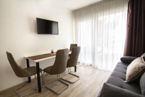 a living room with a table and chairs and a couch at Centinera Apartments in Banjole