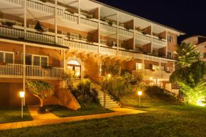 a hotel at night with stairs leading up to it at Residenz am See in Sankt Kanzian