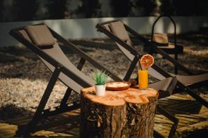 a tree stump with a drink on top of it at A House in Estoril - Adults Only in Estoril