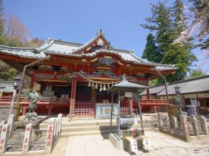 a chinese temple with a statue in front of it at Hotel Wing International Sagamihara in Sagamihara