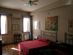 a bedroom with a bed with a red blanket at Antica Locanda Montin in Venice