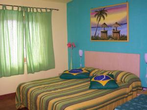 a bedroom with a bed with two pillows on it at Hotel Brutium in Tortora