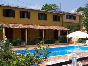 a villa with a swimming pool in front of a house at Hotel Brutium in Tortora +27 photos