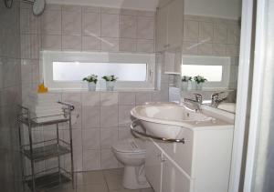 a white bathroom with a sink and a toilet at Winterberg Appartement 21028 in Winterberg